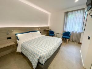 Postel nebo postele na pokoji v ubytování Hotel Locanda Alla Perla