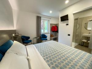 Postel nebo postele na pokoji v ubytování Hotel Locanda Alla Perla