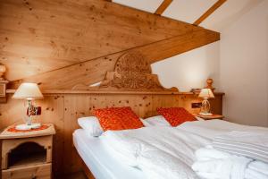 a bedroom with a large bed with wooden walls at R.T.A. La Moretina in Commezzadura