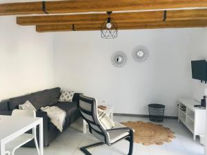 a living room with a couch and a table at Olas de Lobos in Corralejo
