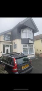 a black car parked in front of a house at roosevelt lodge in Skegness