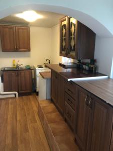 a kitchen with wooden cabinets and a counter top at Садиба "Сонячна" in Kosiv