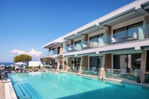 a hotel with a swimming pool in front of a building at Akti Toroni Boutique Hotel in Toroni