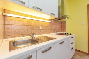a kitchen with a sink and a counter at Apartments Villa Maja in Rogoznica