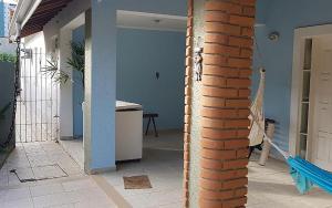 a room with a brick wall and a brick pillar at Casa com churrasqueira no Centro de Caraguatatuba in Caraguatatuba