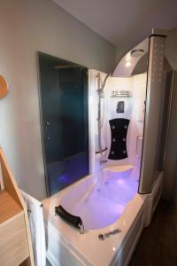 a bathroom with a tub with a black dress in it at Hotel Chamdor in Roeselare