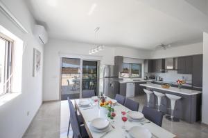 a kitchen with a table and chairs in a kitchen at Villa Marylou in Protaras