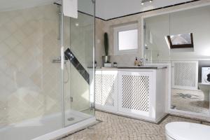 a bathroom with a shower and a toilet and a sink at Cascais Downtown Apartment with Sea View in Cascais