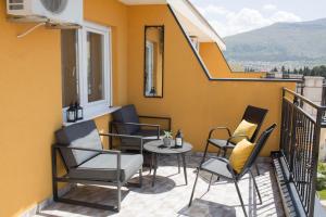 a patio with chairs and a table on a balcony at Bella Vista in Trebinje