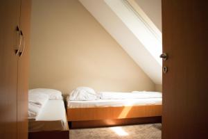 A bed or beds in a room at P4W Hotel Residence Szombathely