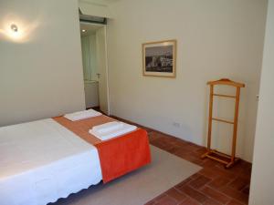 a small room with a bed and a shelf at Fine Arts Convento das Bernardas BB in Tavira +10 photos