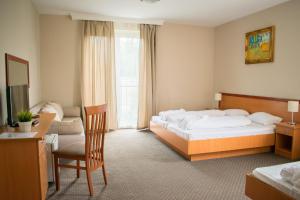 A bed or beds in a room at P4W Hotel Residence Szombathely