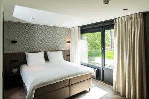 מיטה או מיטות בחדר ב-Hotel de Werelt