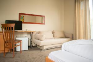 A bed or beds in a room at P4W Hotel Residence Szombathely