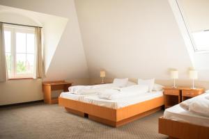 A bed or beds in a room at P4W Hotel Residence Szombathely