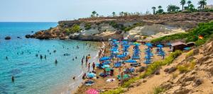 a beach with a bunch of people in the water at Lovely house not far from the beach, near Protaras in Dherinia