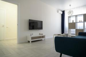 a living room with a television on a white wall at Arkadia apt in Odesa