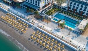 an overhead view of a pool with umbrellas and a beach at Sundia Exclusive By Liberty Fethiye Adults Only in Fethiye