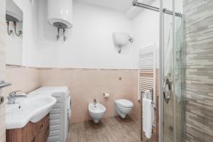 a bathroom with a sink and a toilet and a shower at Dreamers' House Sorrento in Sorrento