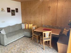 a living room with a couch and a table at Bloserhof Kaschmann in Zellberg