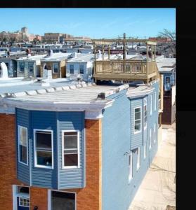 a group of houses with a balcony on top of them at Downtown upper canton 3 bdrm 3 bath home with rooftop and parking pad in Baltimore