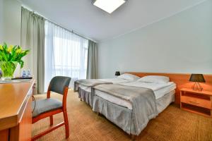 
Ein Bett oder Betten in einem Zimmer der Unterkunft Sanatorium Uzdrowiskowe Bałtyk
