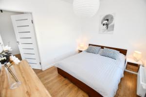 Posteľ alebo postele v izbe v ubytovaní Apartament Słoneczny przy Rybackiej