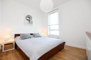 Posteľ alebo postele v izbe v ubytovaní Apartament Słoneczny przy Rybackiej