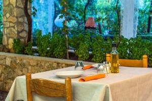 a table with a white table cloth and a bottle of oil at Casa Colletta Vieste in Vieste