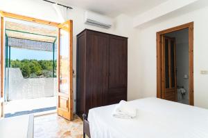 a bedroom with a bed and a large window at Casa Colletta Vieste in Vieste
