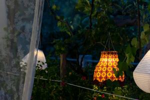 a lamp hanging from a string in a garden at Casa Colletta Vieste in Vieste