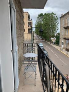 a table on the balcony of a building at Au cœur de sartene in Sartène