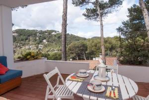a table and chairs on a patio with a view at Sa Tuna "Casas CE MA" in Begur