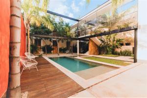 a house with a swimming pool and a patio at Casa de Las Palomas Boutique Hotel by Paloma's Hotels - Adults Only in Mérida