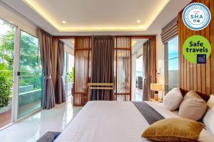 a bedroom with a bed with a sale travels sign on it at Ao Luek Panoramic Pool-SHA Plus in Ao Luk