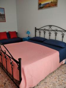a bedroom with a bed with a red and blue blanket at Sassi Planet in Matera