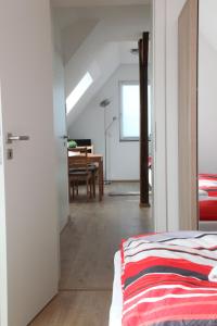 a bedroom with a bed and a dining room with a table at Schwaben Apartment Plus in Oberboihingen