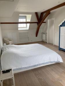 a bedroom with a white bed and a window at House Zoute Stables 125sqm in 5 Ha property near seaside in Knokke in Knokke-Heist