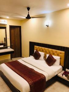 a bedroom with a large bed and a piano at HOTEL AUGUSTO in Varanasi