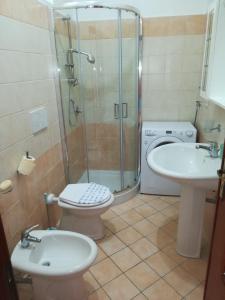 a bathroom with a shower and a toilet and a sink at Casa Sisina in Conca dei Marini