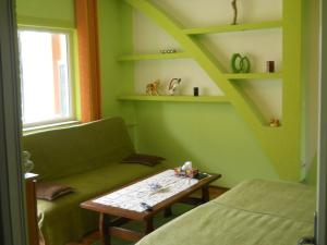 a room with a couch and a table and shelves at Pensiunea Cora in Piteşti