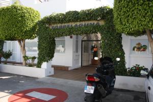 a scooter parked in front of a building at Apartamentos Torrelaguna in Vera