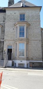 a large brick building with windows on a street at Bunny Burrow in Whitby