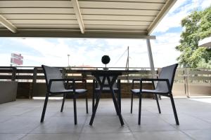 a black table and chairs on a patio at On Board Luxury Studios in Sarti