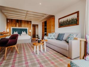 a living room with a couch and a table at Sendlhofer's in Bad Hofgastein +201 photos