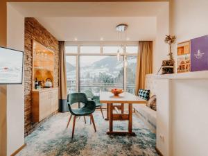 a room with a table and a bedroom with a view at Sendlhofer's in Bad Hofgastein