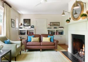 a living room with a couch and a fireplace at Oakhurst Inn in Charlottesville