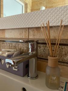 a bathroom counter with a sink and some bamboo sticks at DALIM in Duliby