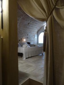 
a bedroom with a bed and a window at LA DIMORA DELLE 3 ZIE in Matera
