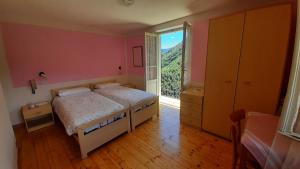 a bedroom with a bed and a large window at ALBERGO BELVEDERE in Orasso